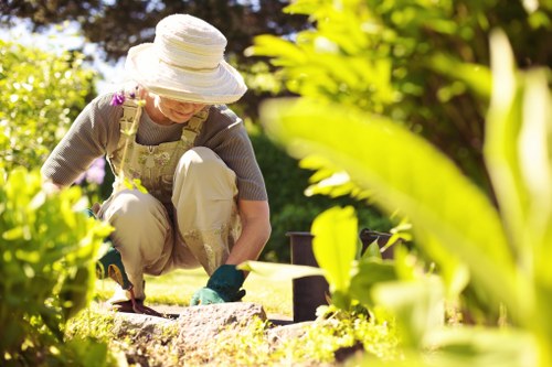 Gardener working in a Balham front garden with tools