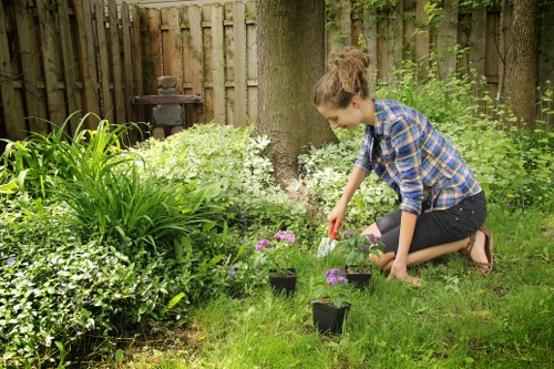 Worker putting on PPE before starting garden maintenance